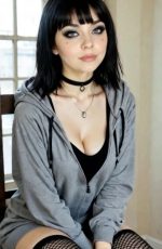 Candy AI character Olivia Carter sits casually on a chair wearing a hoodie and black choker, posing indoors with soft natural lighting.